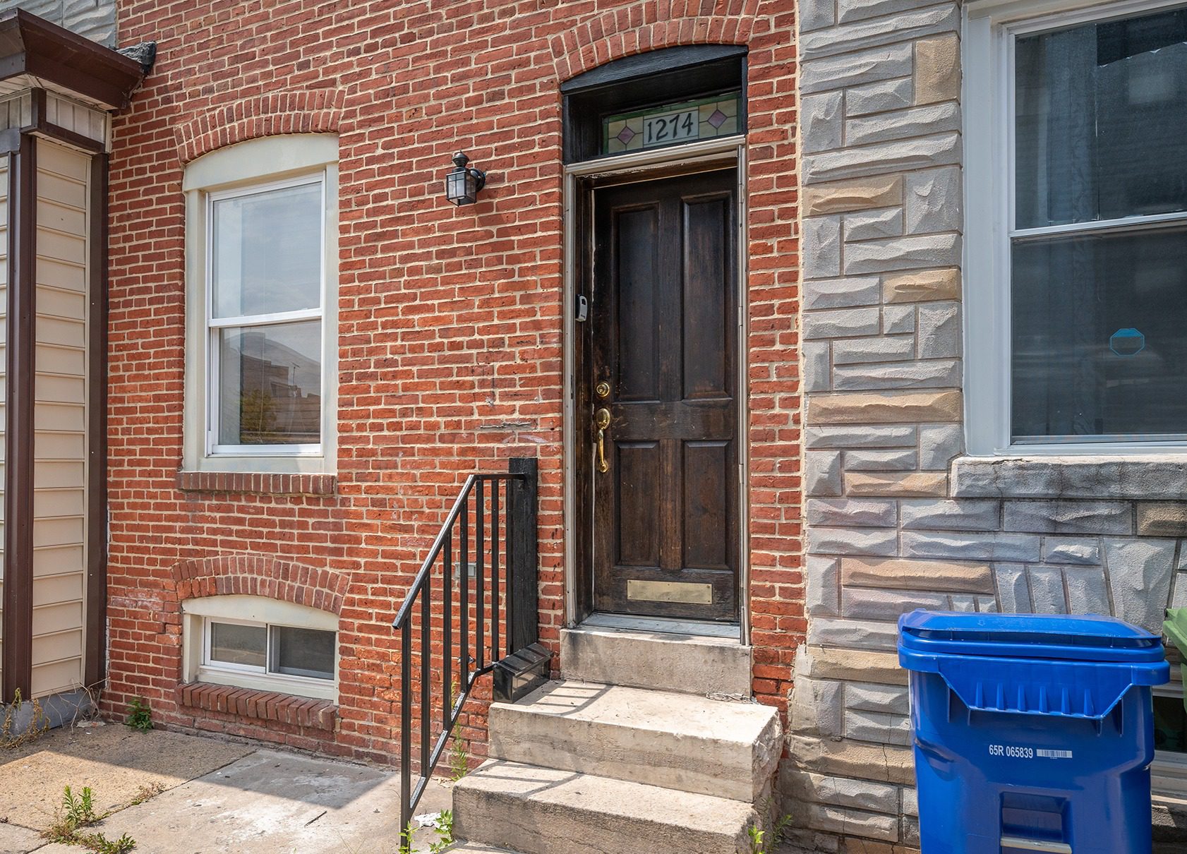 a brick building with a door and steps leading up to it