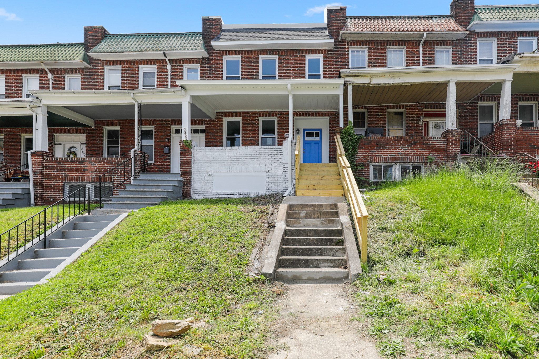 an apartment building with stairs leading up to the front door