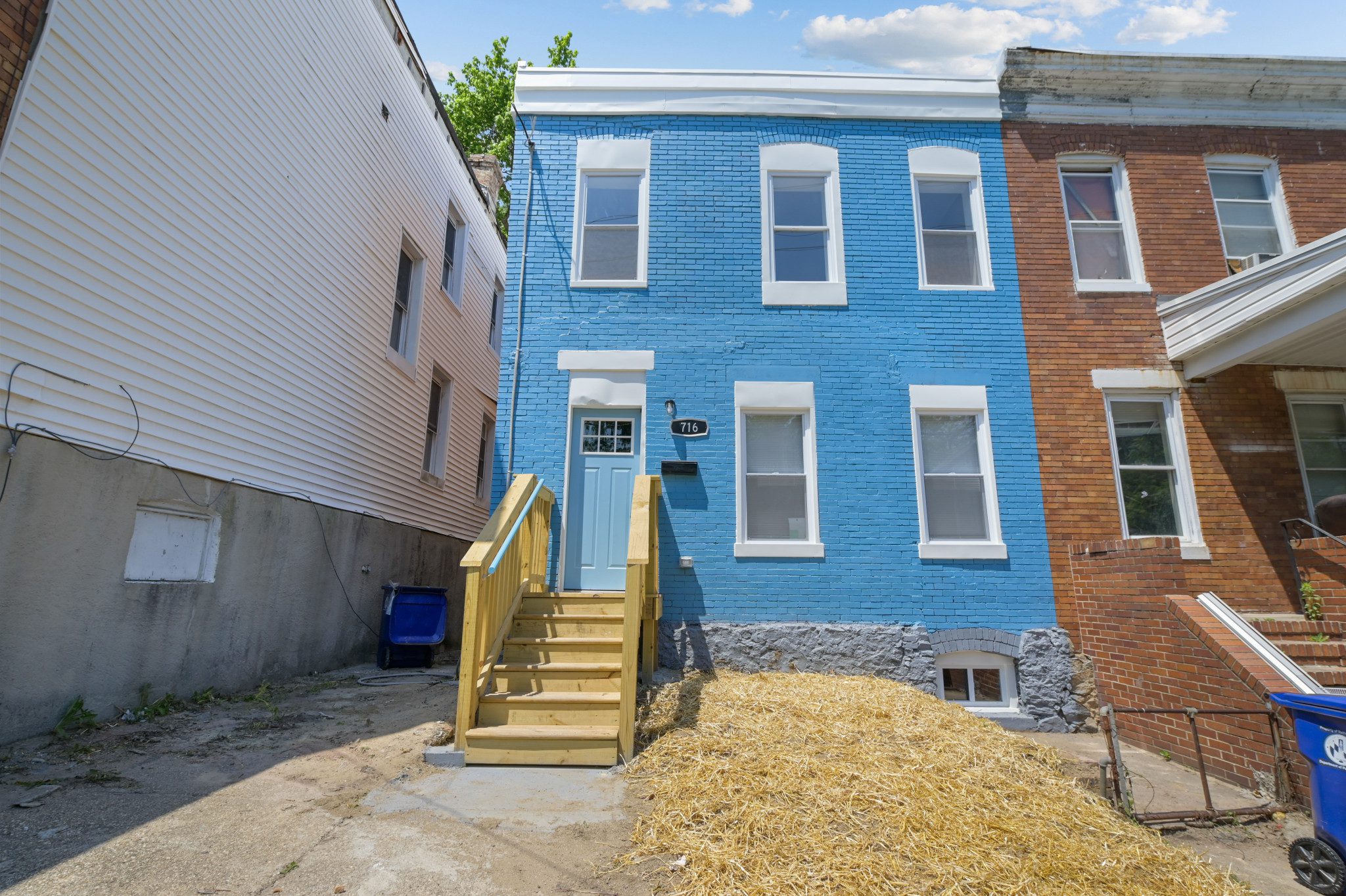 a blue house with stairs leading up to it