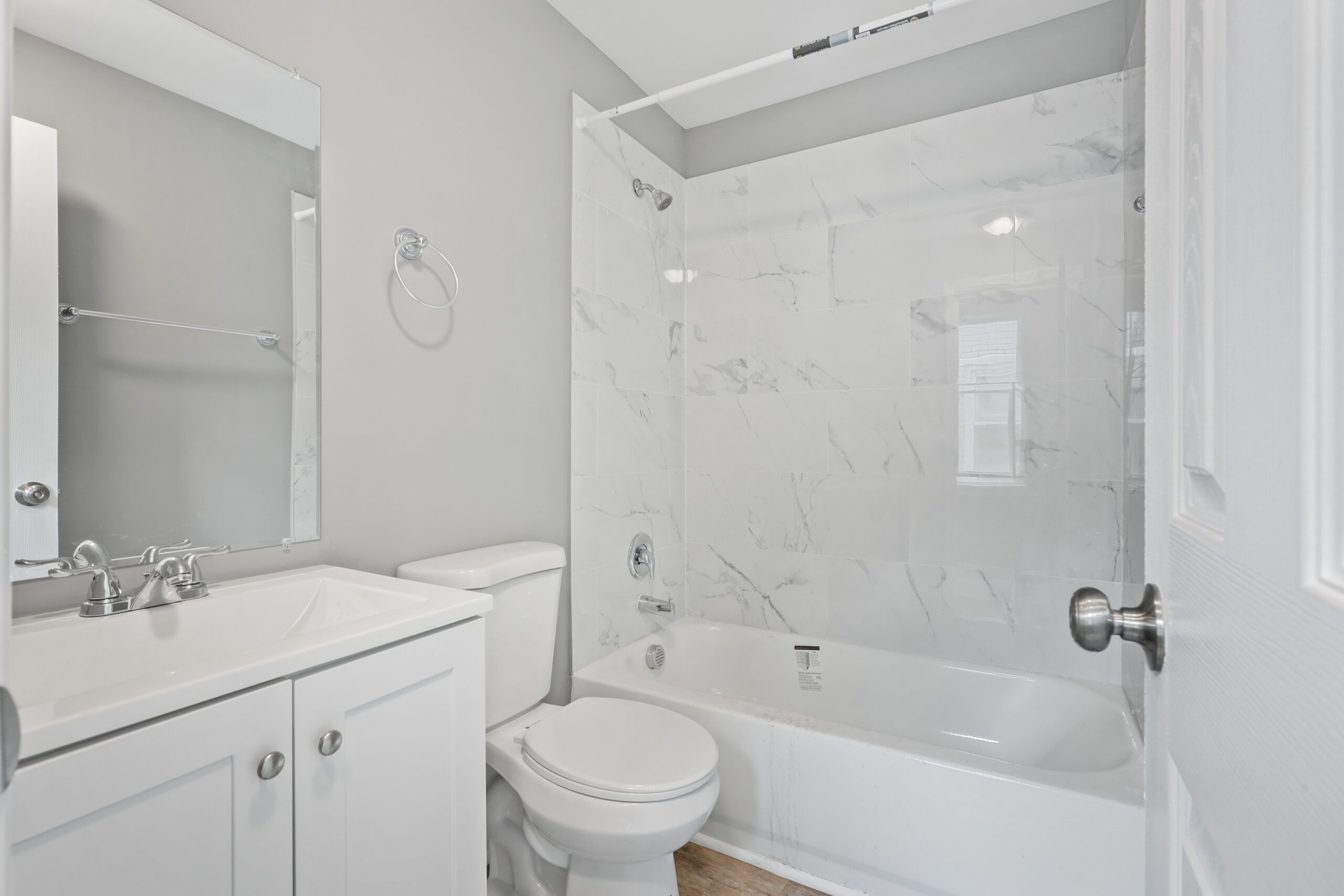 a white bathroom with a toilet, sink and bathtub