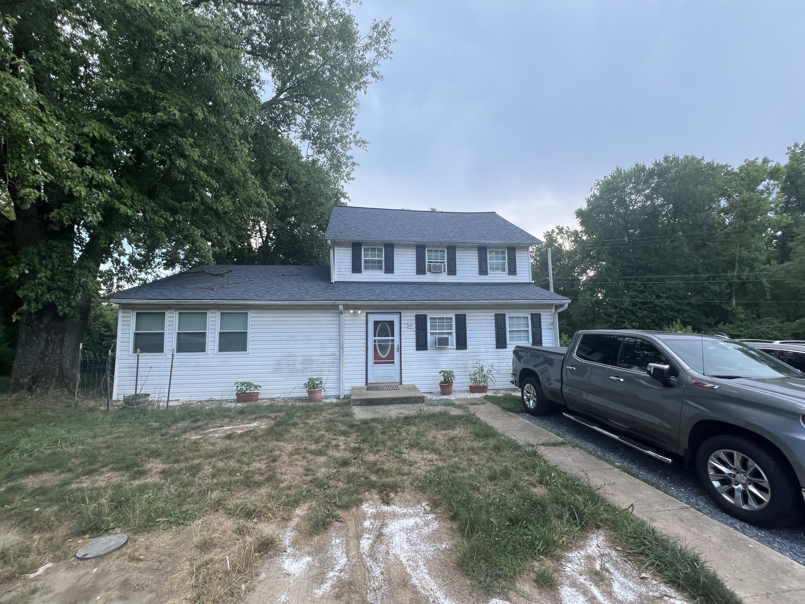 a car upside down in front of a house