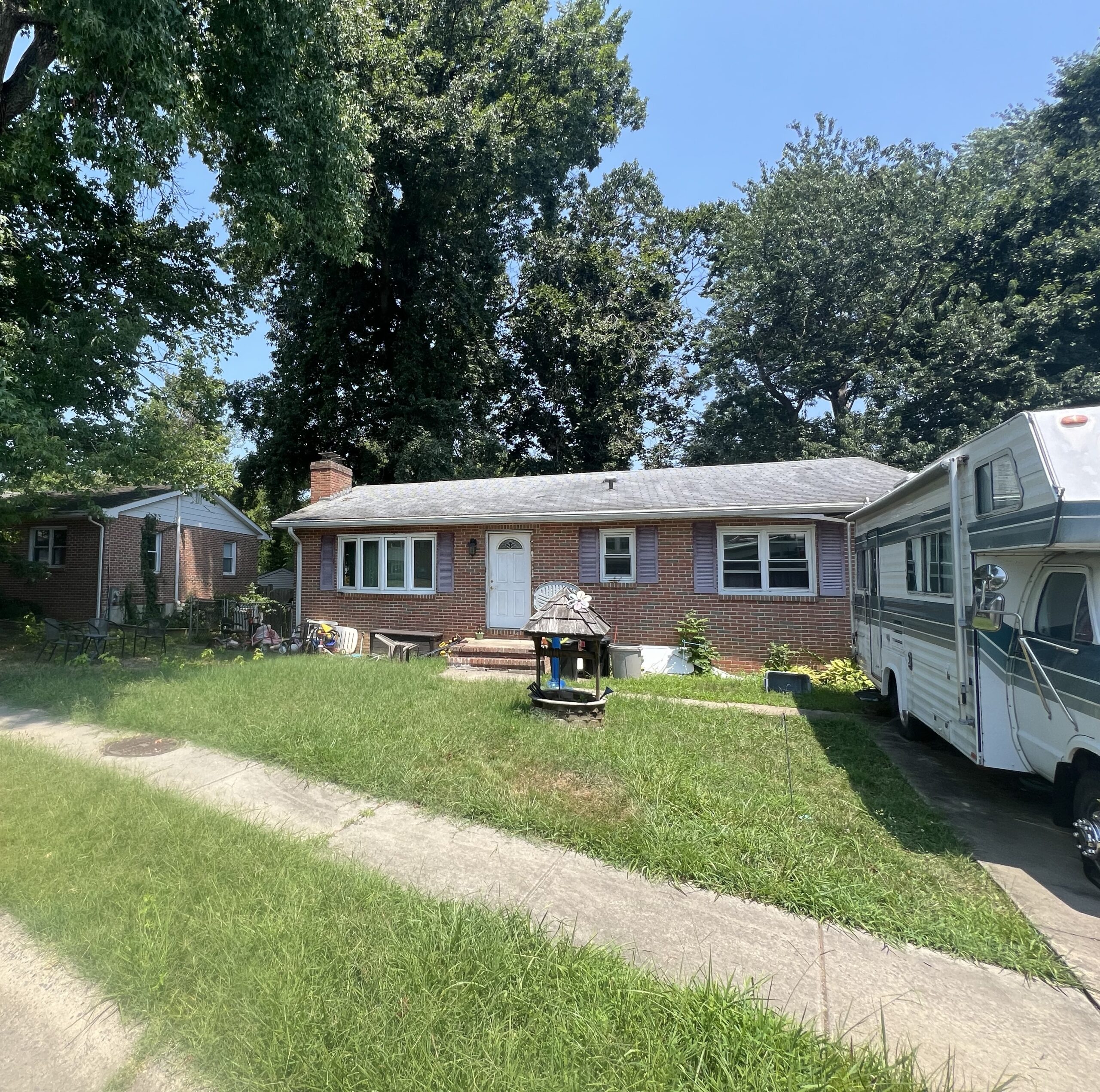 a house with a trailer parked in front of it