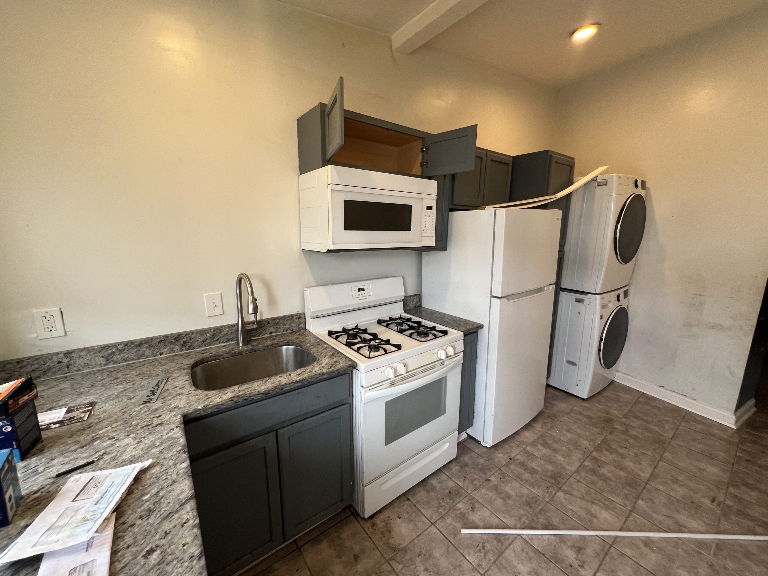 a kitchen with a stove, microwave and refrigerator