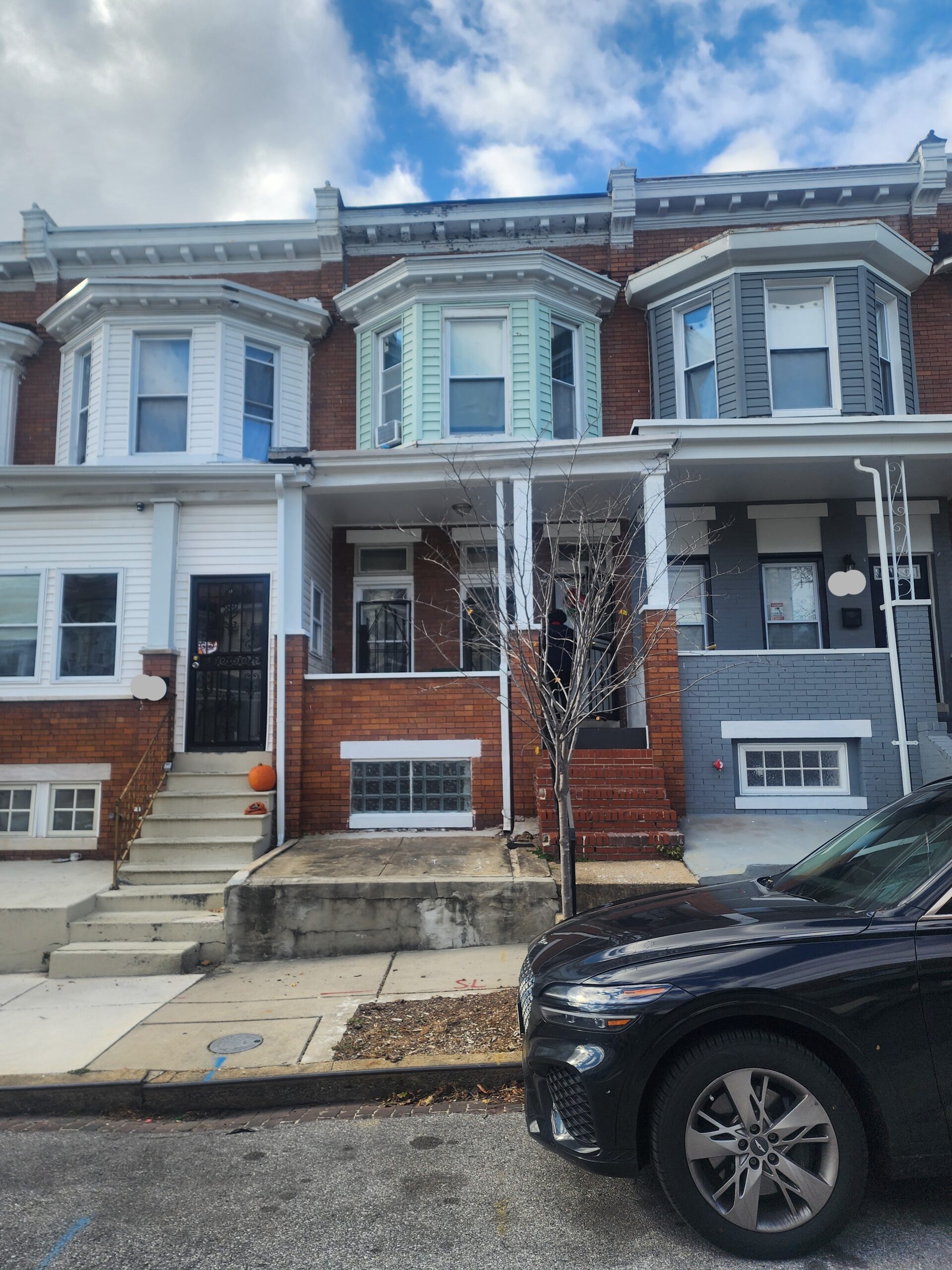 a car parked in front of a row of houses