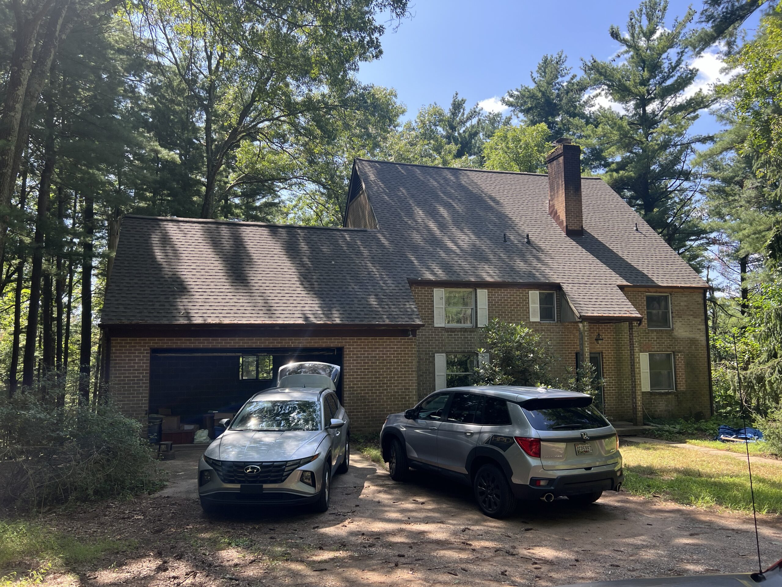 two cars are parked on the roof of a house