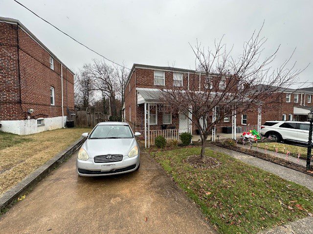 a car parked in a driveway next to a brick building