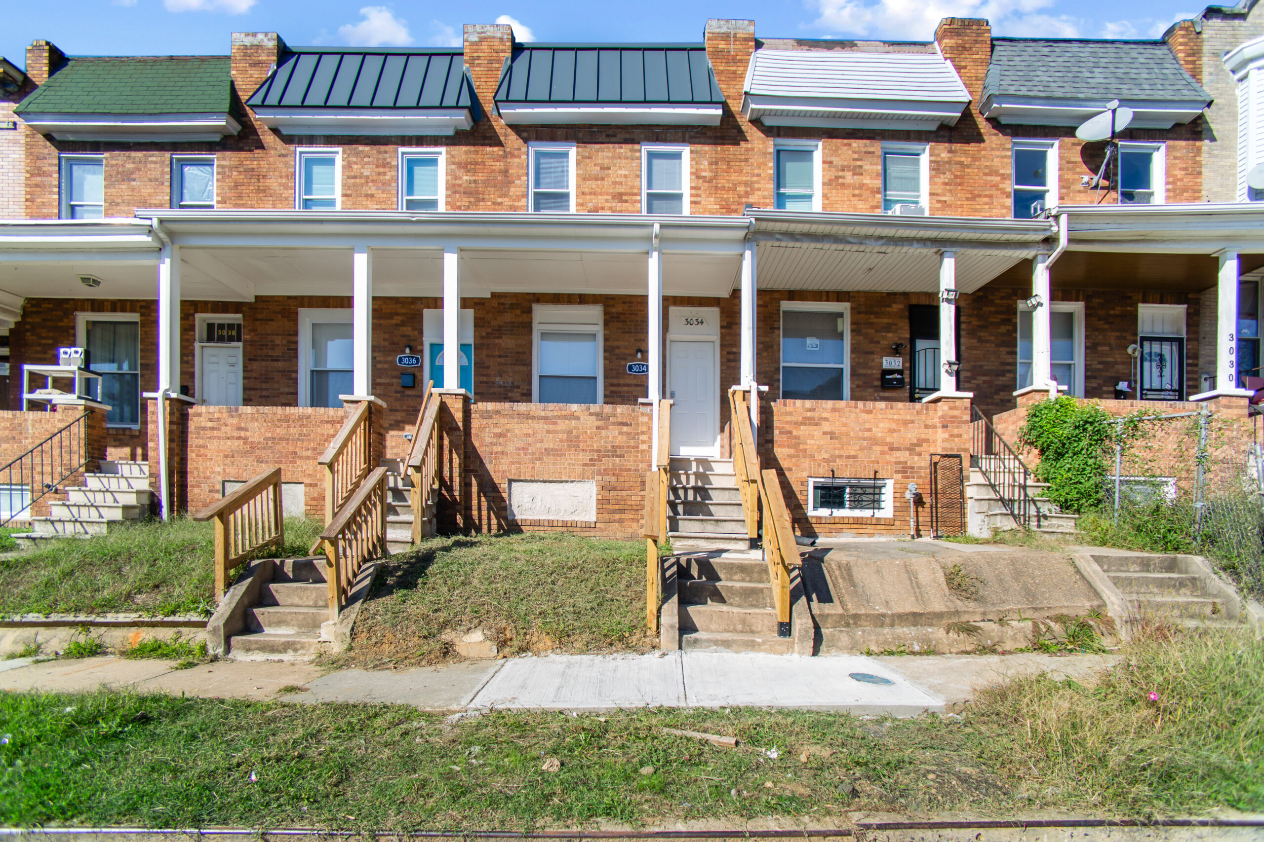 a row of brick houses with white pillars