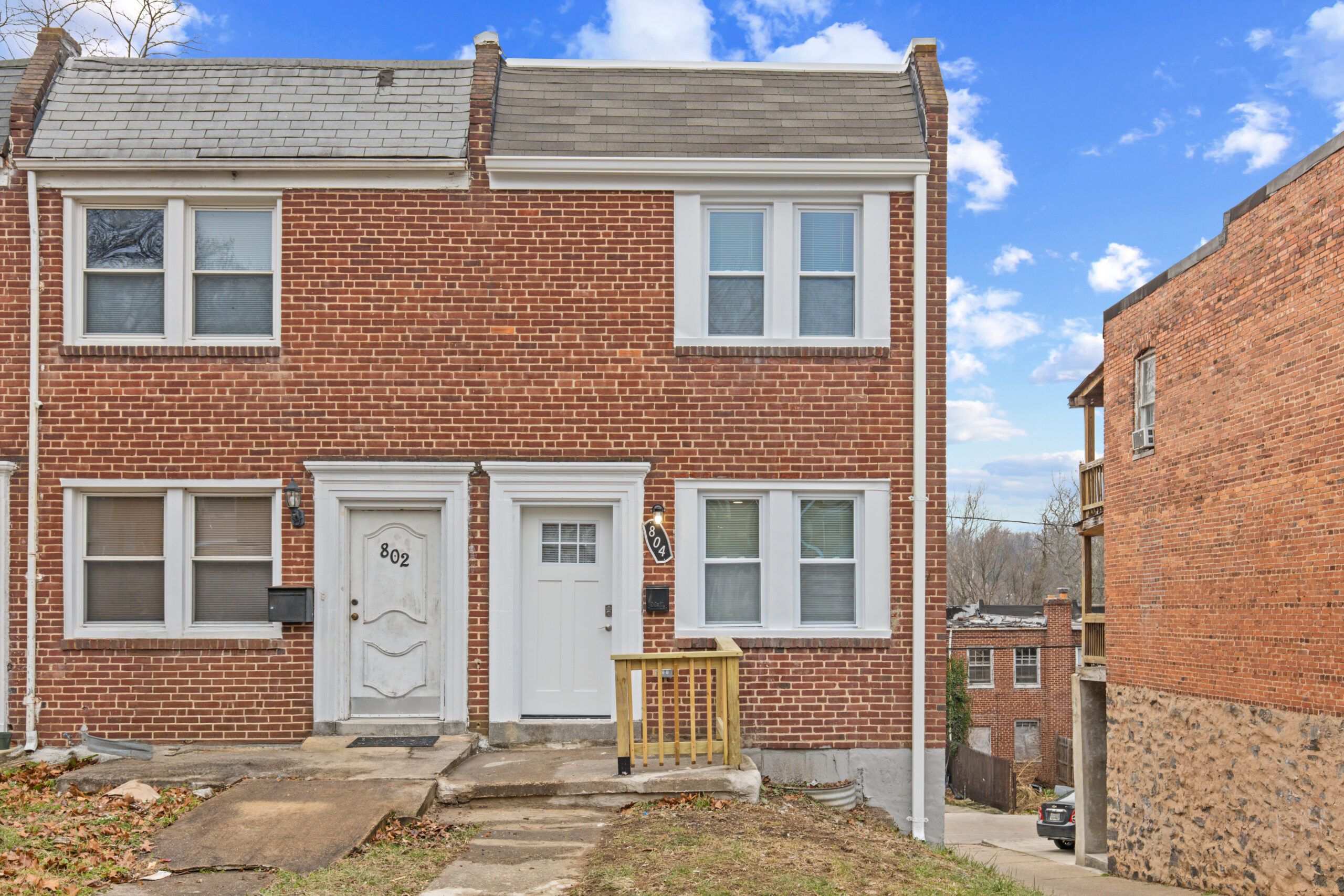 a brick two story house with a white door